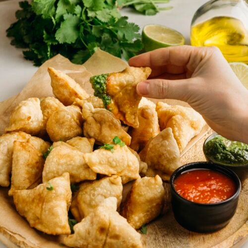 close-up-hand-holding-pakistani-food